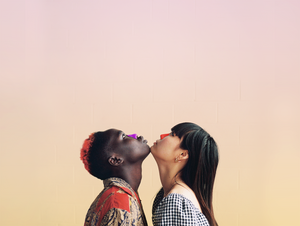 Boy and girl touching chins while wearing purple and orange Nöz Sunscreen