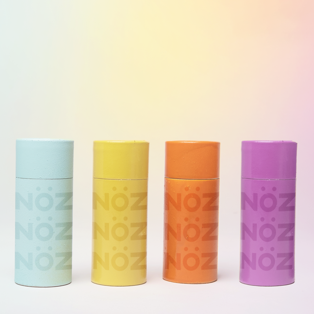 Aligned orange, yellow, blue and purple Nöz Sunscreen with reef-safe SPF formula